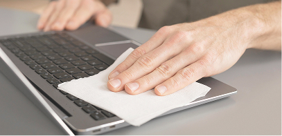 Photo d’un technicien nettoyant le clavier d’un ordinateur portable